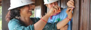 Nicaragua staff member helps a trainee with hands-on installation