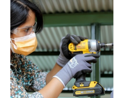  Katherine uses an impact drill.